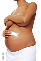 Pregnant woman treats stretch marks